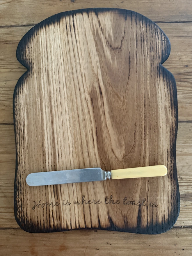 Large engraved toast board Home is where the toast is with large vintage butter knife with cream handle.