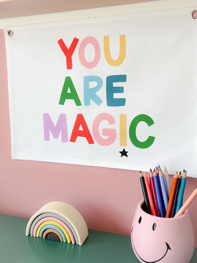 You are magic wall banner hanging on a pink wall