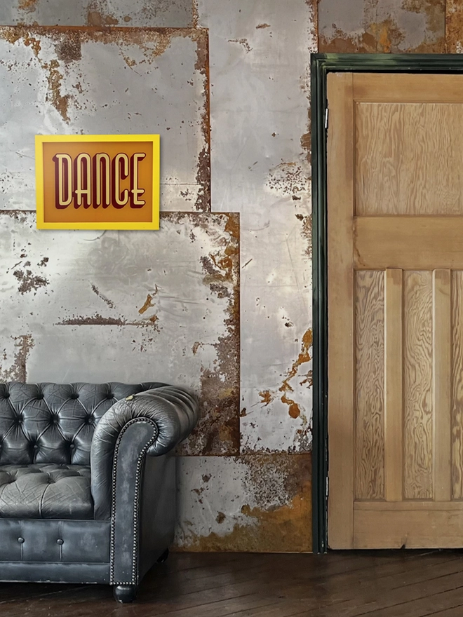 Dance yellow gold leaf on glass framed detail. on metal wall