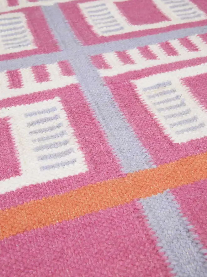 Labourdonnais Flatweave Rug, a colourful rug sitting on a plain surface. 