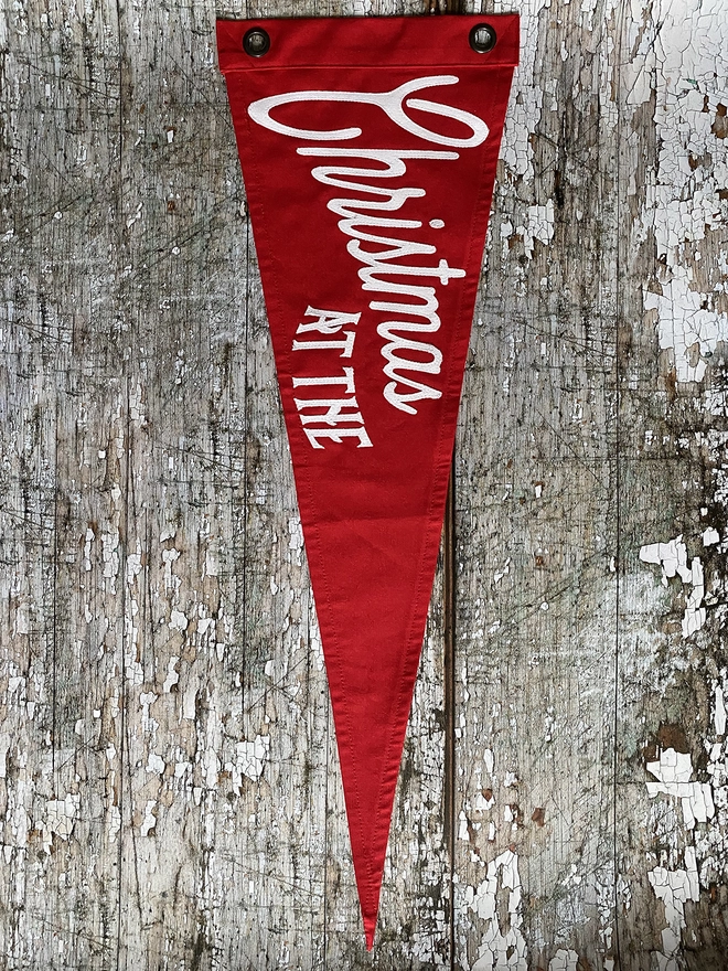 red pennant flag with white writting Christmas at the
