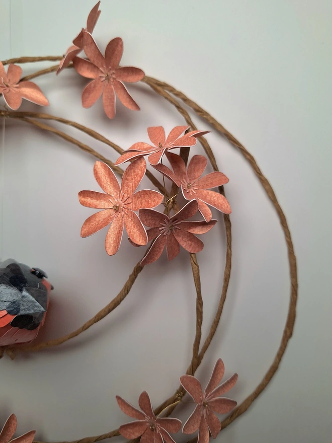 close up of the peach flowers on the floral wreath