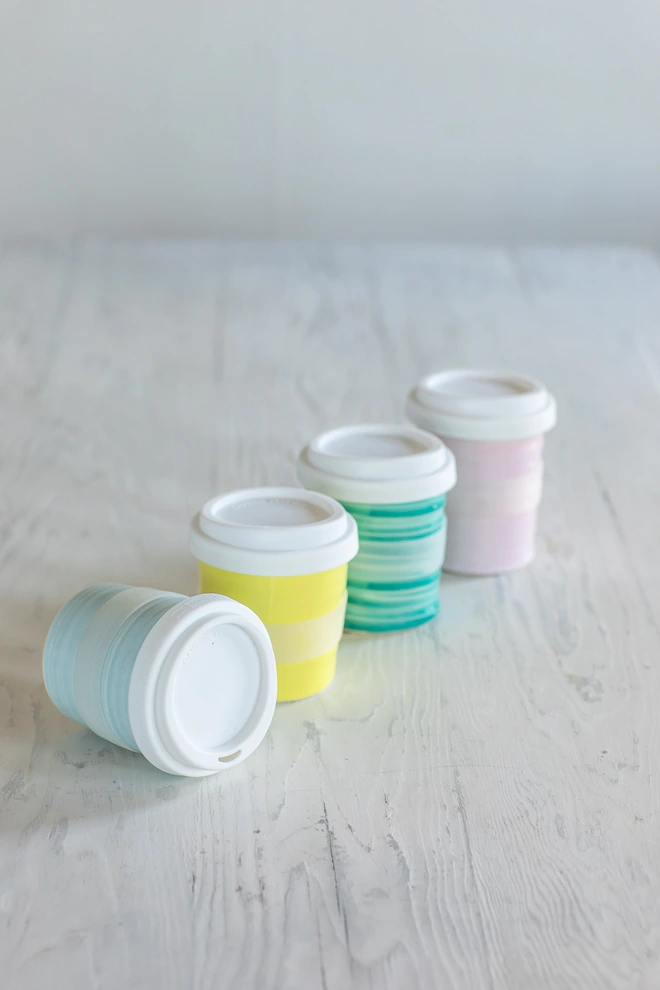 Turquoise, yellow, green and pink travel cups