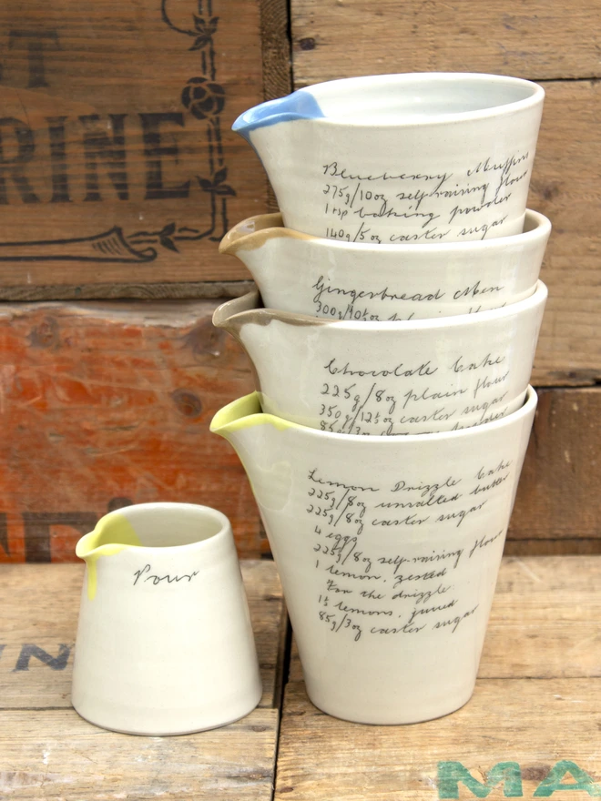 stack of handheld recipe jugs next to mini pour jug