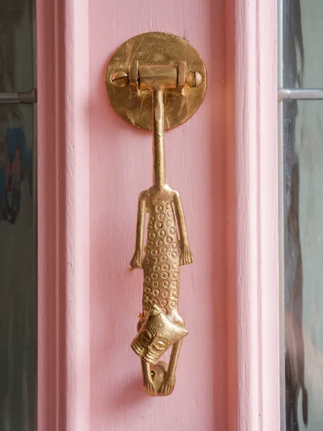 leopard door knocker on a pink door