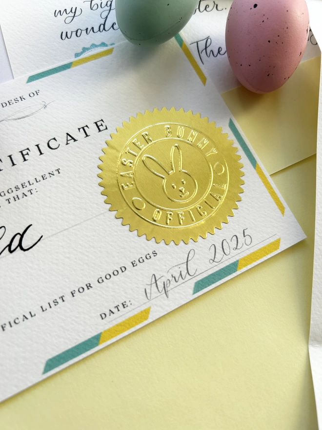 Letter and 'Good Egg' official certificate from the Easter Bunny Rabbit with bunny Easter basket illustration, calligraphy and golden embossed stamp with blue and yellow border