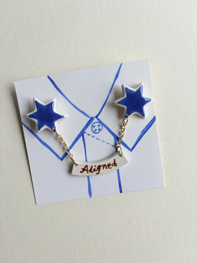 Star collar pins. A pair of stars aligned collar pins on a collar hand-sketched on paper