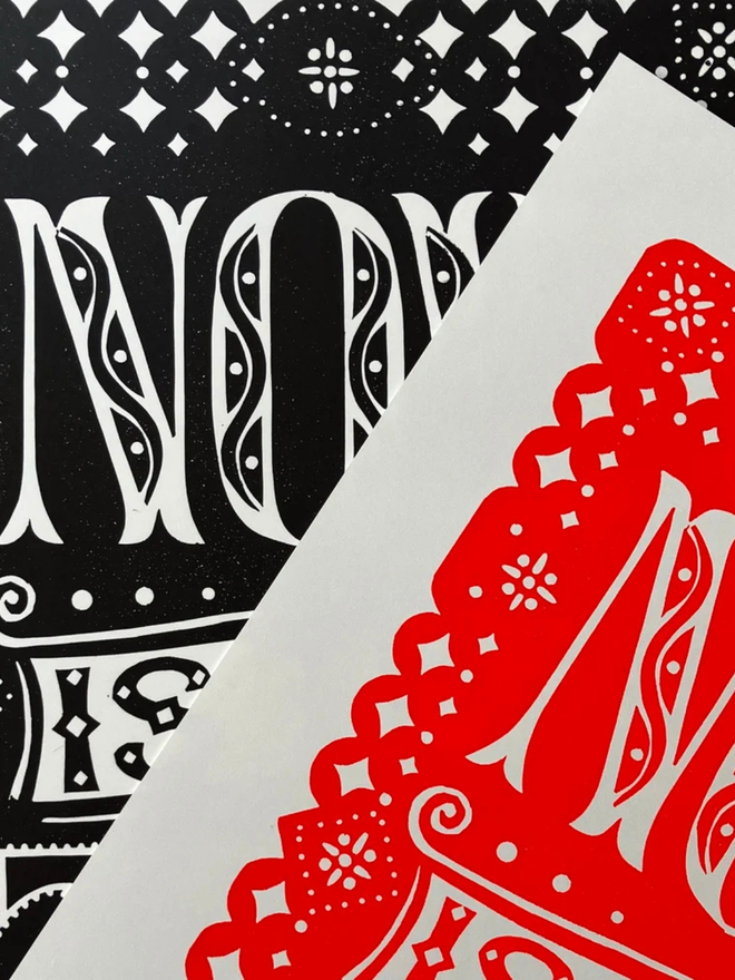 now is the time linocut. a linocut phrase printed on red and black paint.