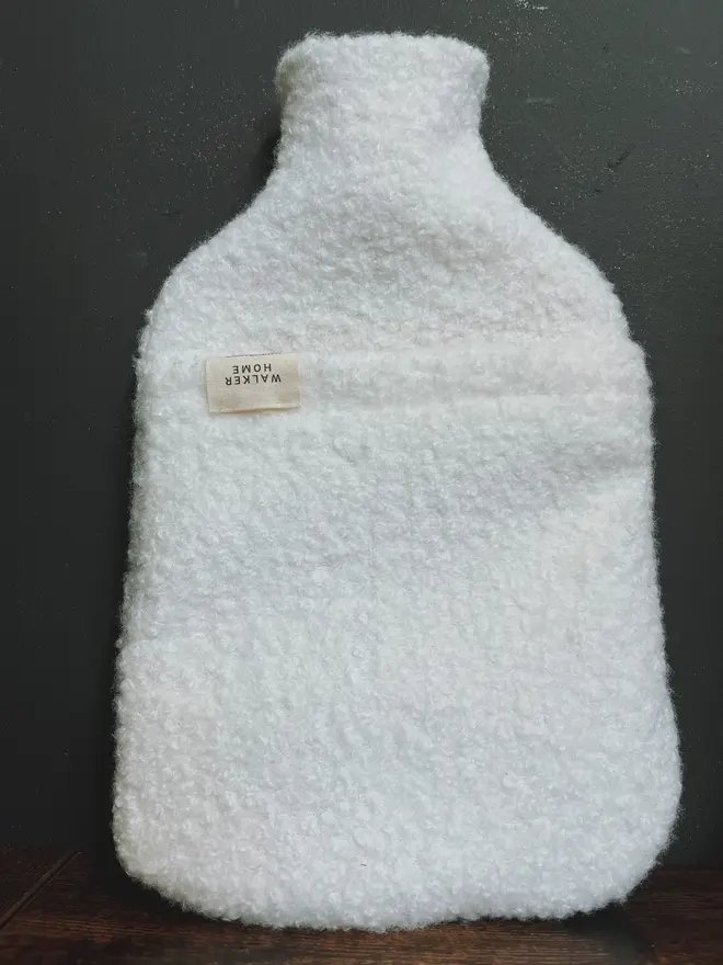 hot water bottle with white wool cover