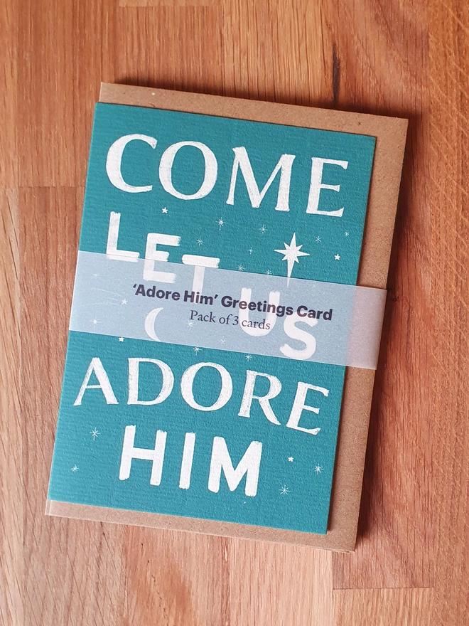 Green Christmas card with carol words from 'O come all ye faithful'