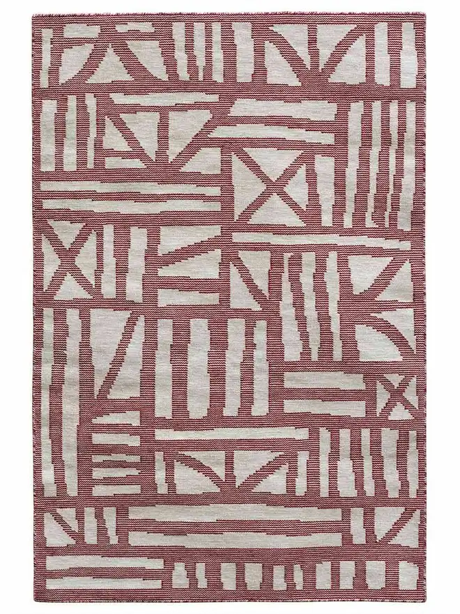 Tudor Flatweave Rug, a colourful rug on a white surface. 