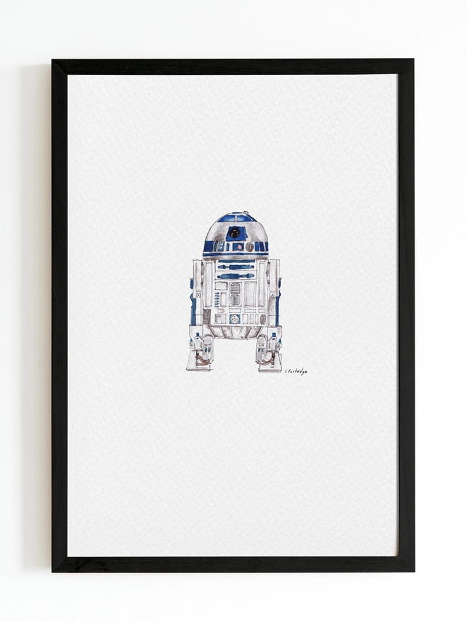 Hand drawn and painted watercolour illustration of R2D2 with a detailed yet organic and slightly loose style. The painting is a small illustration sitting on a white background within a black frame. 