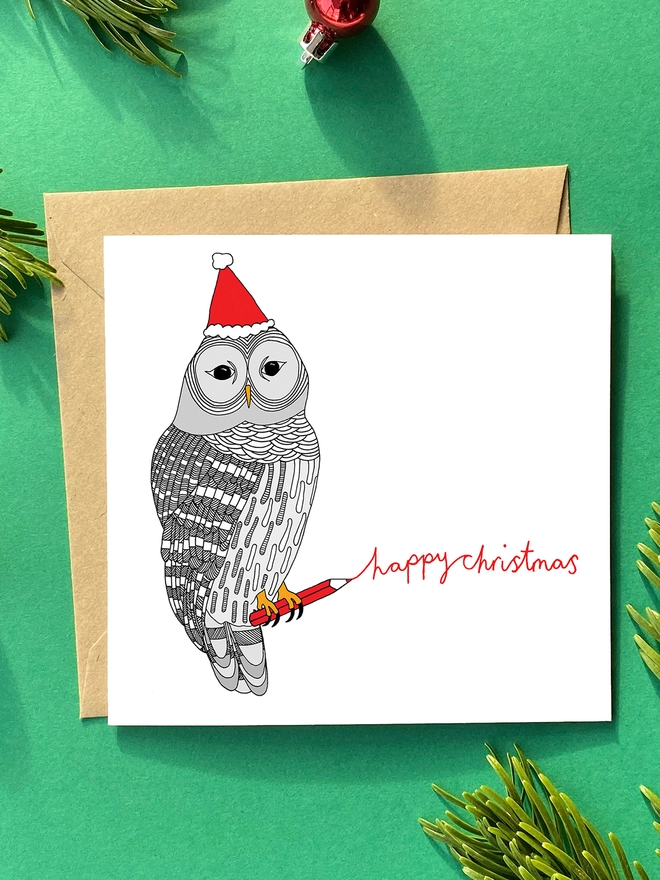 Christmas card with a jolly owl in a hat