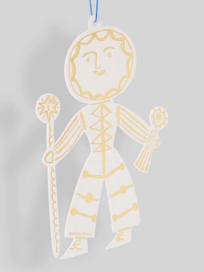 Decorative Sun Folk ornament with gold detailing on a gray background