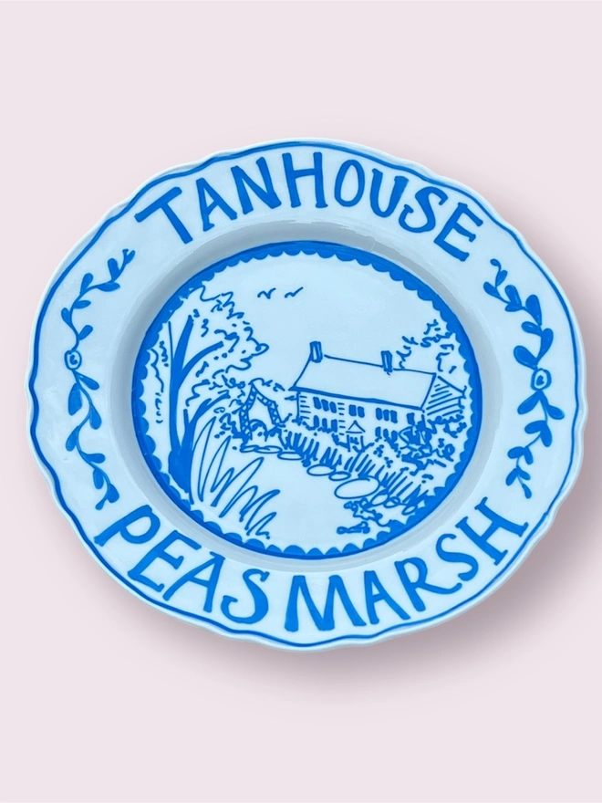 hand-painted cottage with name and location in blue and white