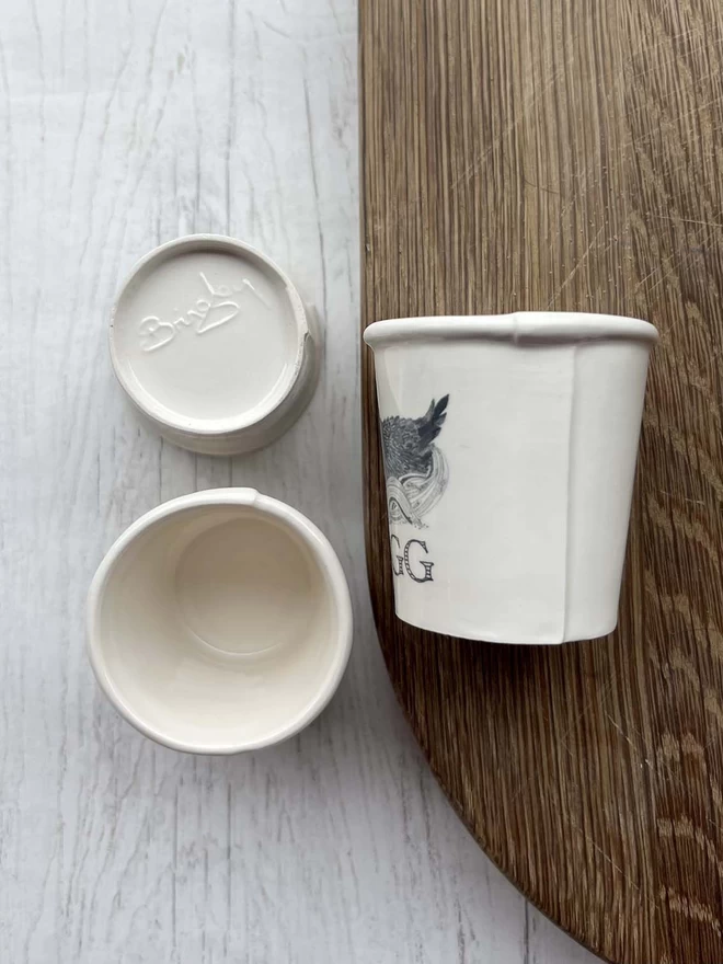 3 handmade ceramic egg cups are showing different views from above, side and base.