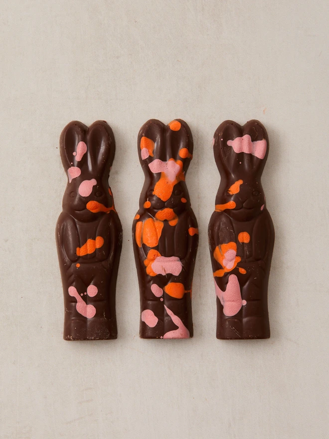 magic chocolate bunnies. a pack of three chocolate bunny rabbits photographed against a plain background.