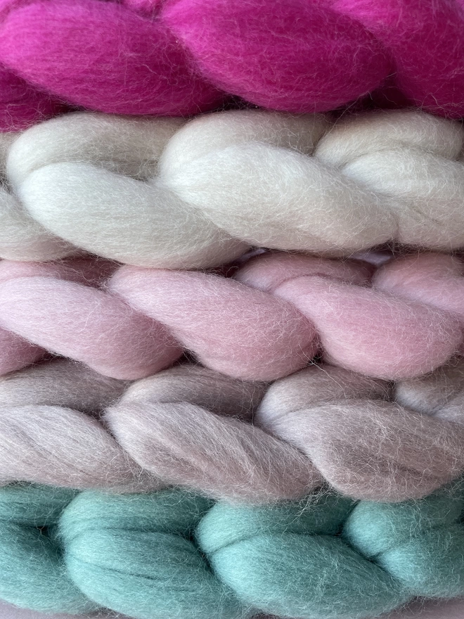 A close up of merino woolly hearts showing the stitches and colours