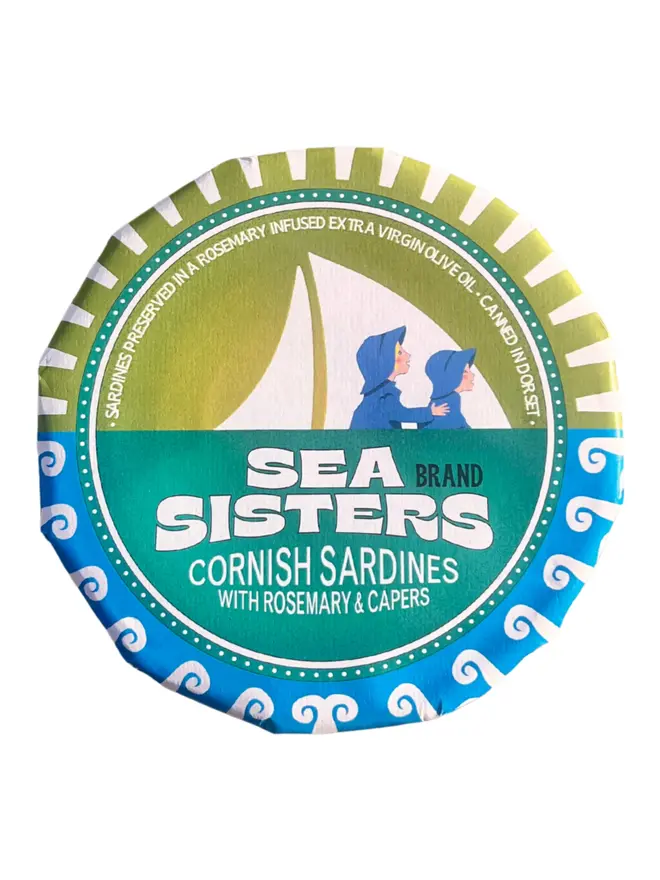 A closed tin of Sea Sisters Cornish Sardines with Rosemary and Capers on a white background