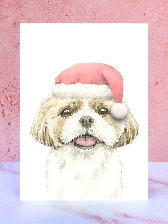 A Christmas card featuring a hand painted design of a shih-tzu, stood upright on a marble surface. 