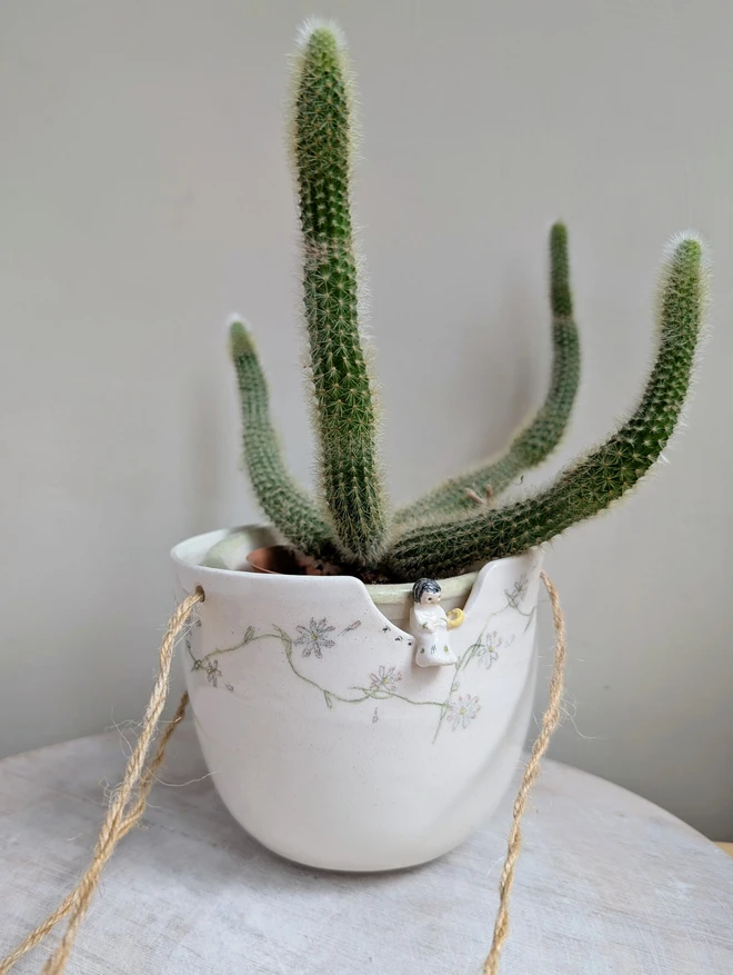 Angel Planter with cactus plant, pot with daisy chain daisies and a miniature angel