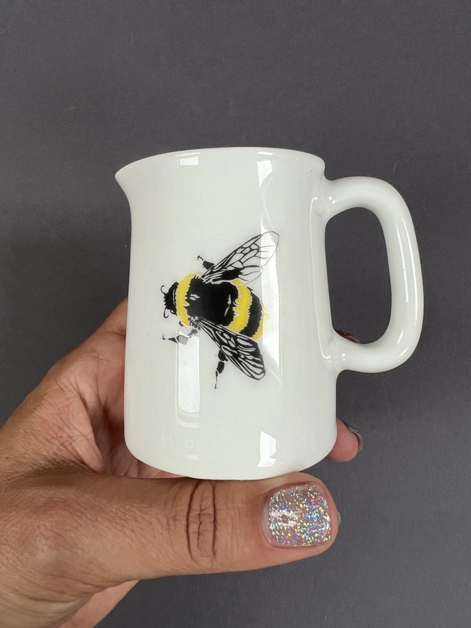 Front of the 1/4 pint jug showing a cute little black and yellow bee