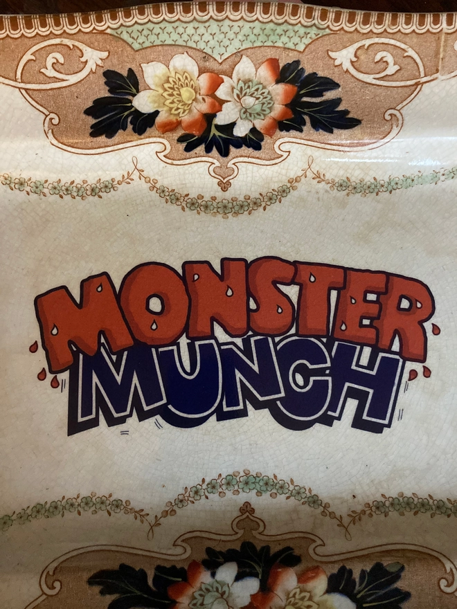 Close up of the 'Monster Munch' logo on this vintage hand printed plate.