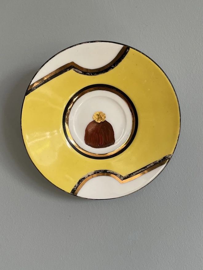 yellow saucer with chocolate painting
