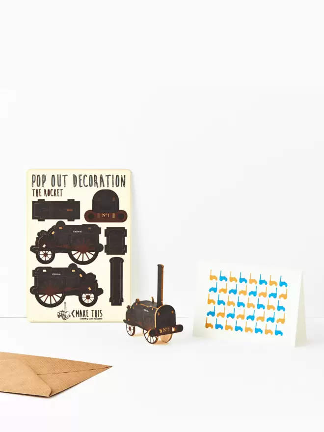 Stephenson's Rocket train decoration and train pattern greeting card and brown kraft envelope on a white background