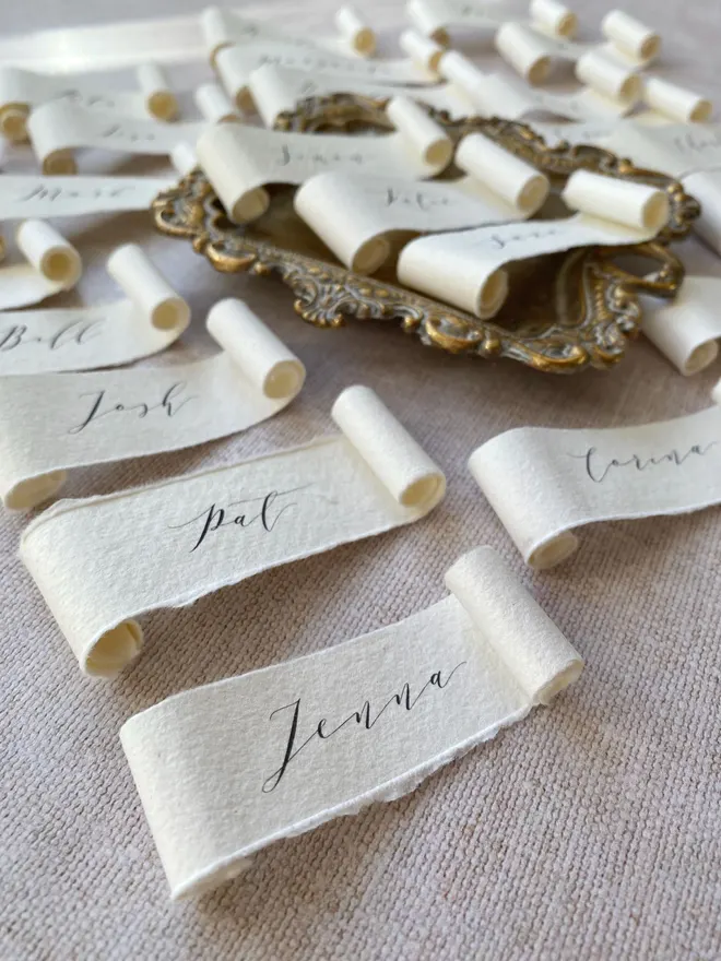 Handmade paper scroll place names for weddings