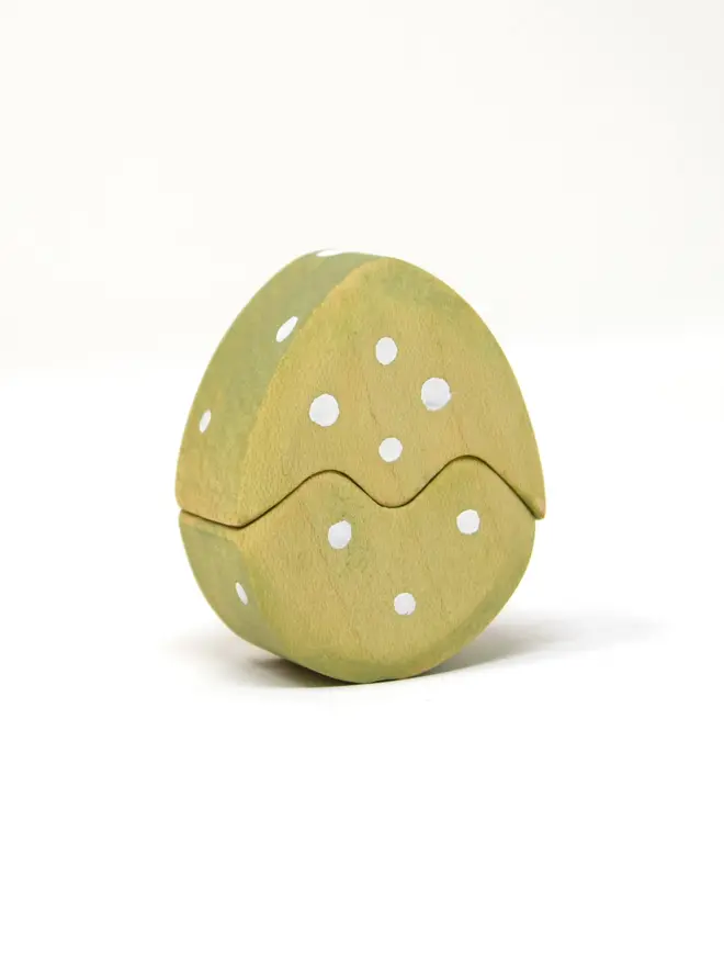 green easter egg with white dots. easter egg can be seperated into 2 pieces