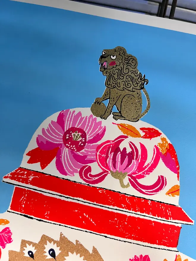 Peacock Vase Are You Looking At Me (You Probably Should), a colourful vase design on a blue screenprint, sitting against a studio rack. 