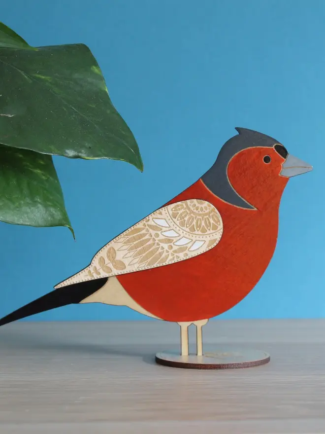 Standing Wooden Chaffinch, red wooden bird decoration standing on a platform. 