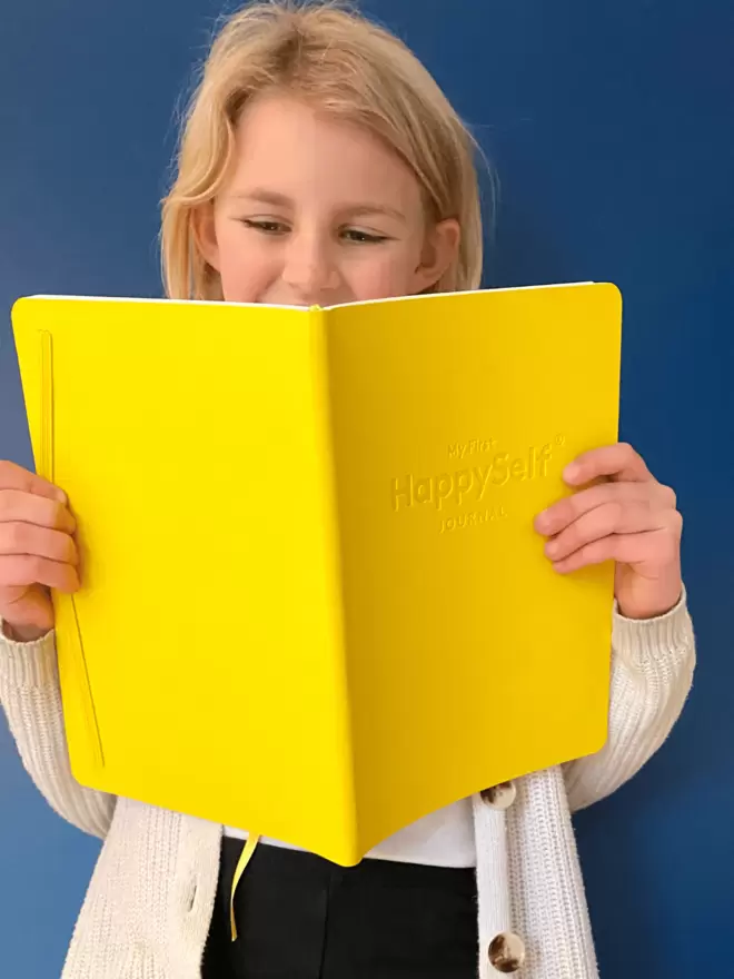 Girl holding the My First Journal 