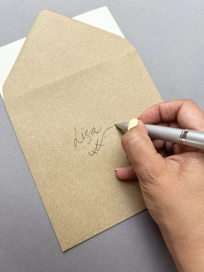 showing the kraft envelope being written on