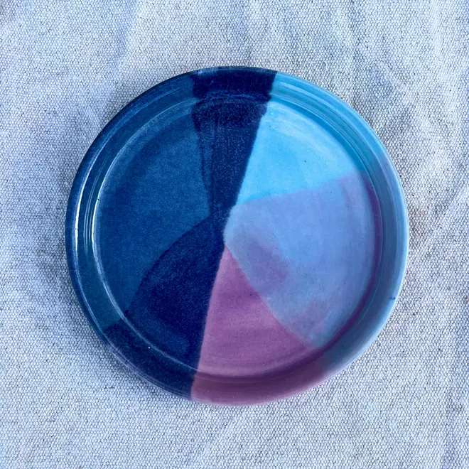 Landscape Side Plate, a colourful plate placed on a stone surface. 