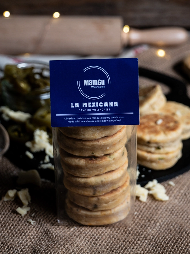 packaged La Mexicana Savoury Welsh Cakes with Jalapenos, cheese, griddle bakestone and rolling pin in the background