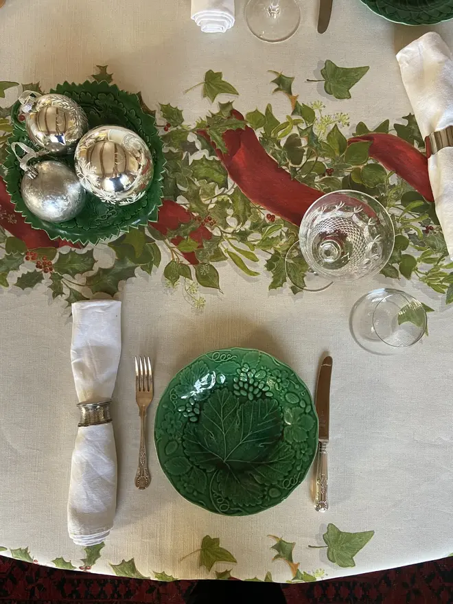 christmas garland centrepiece tablecloth. a white tablecloth emblazoned with a christmas garland on a table.