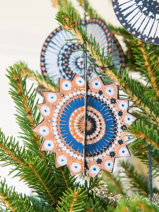 blue and orange star decoration hanging on tree