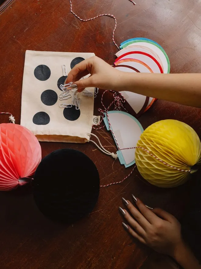 Paper balls garland in a spotty cotton bag