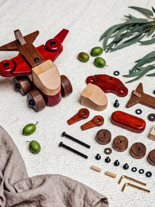 Walnut & Padauk Aeroplane Wood Heirloom Toy, dismantled on a table. 