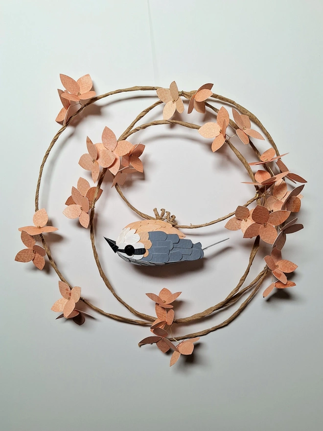 nuthatch bird sculpture on a peach hydrangea wreath
