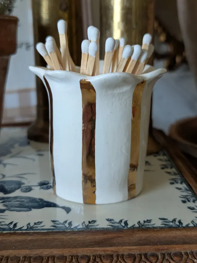 Gold stripe ceramic match striker. Hand made with white safety matches