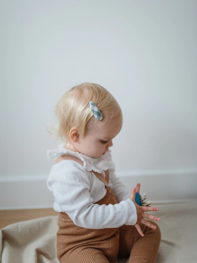 Baby with set of three hair clips 