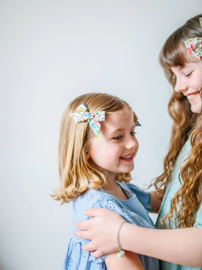 girls laughing with their liberty floral hair bows