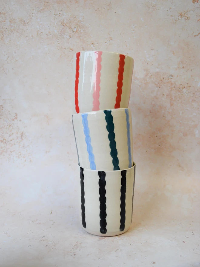 Handmade ceramic Stripe Pop tumblers — stacked tumblers in blue and red stripes