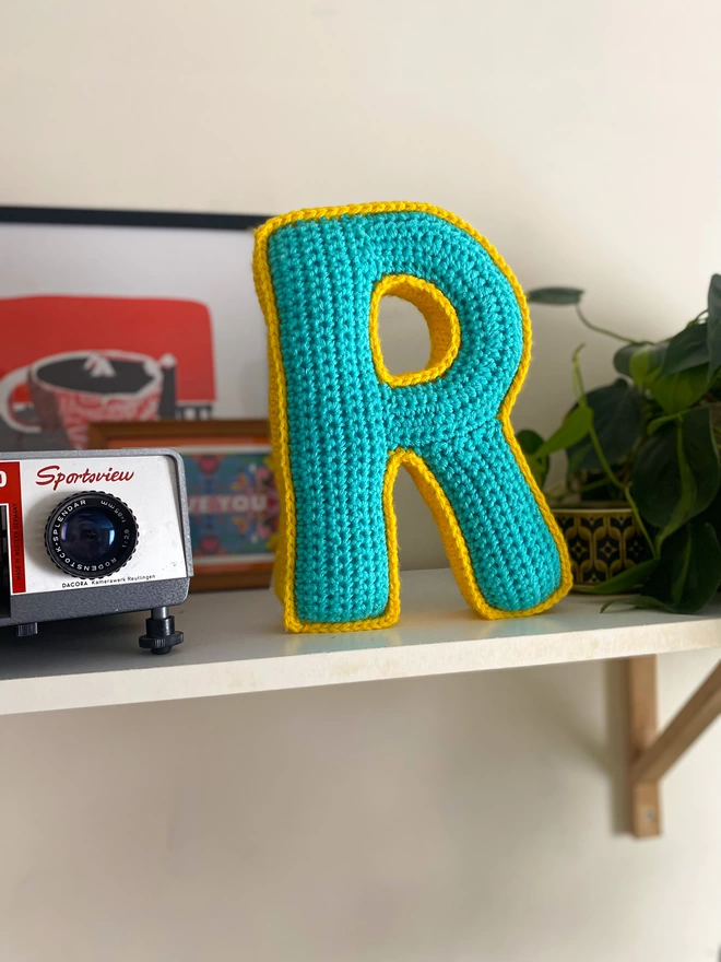 Crocheted Cushion shaped like an R in Teal and Sunshine Yellow