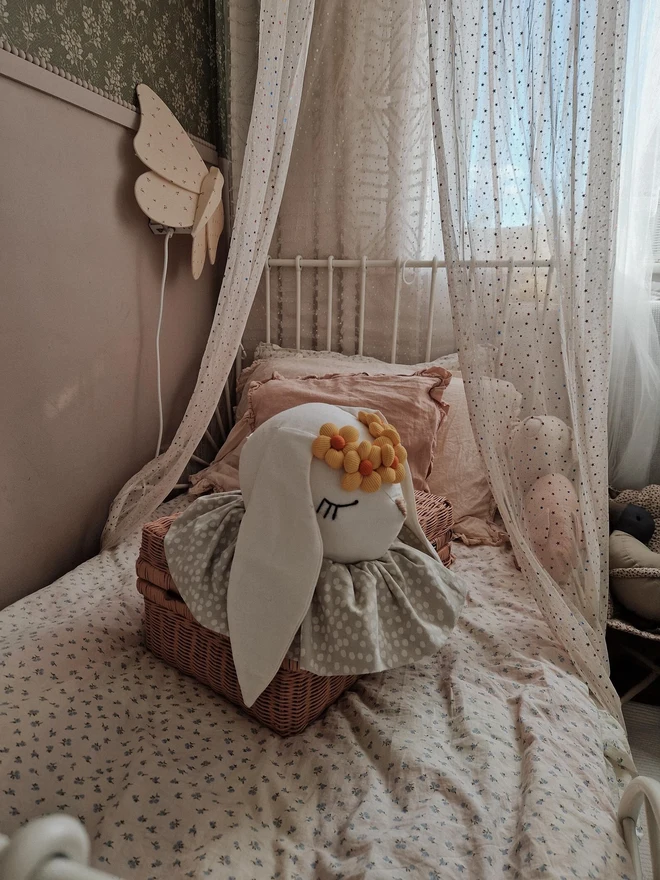 Rabbit Head Wall Mount, a cotton rabbit head wall decoration in a child's bedroom accompanied by other bedroom accessories. 
