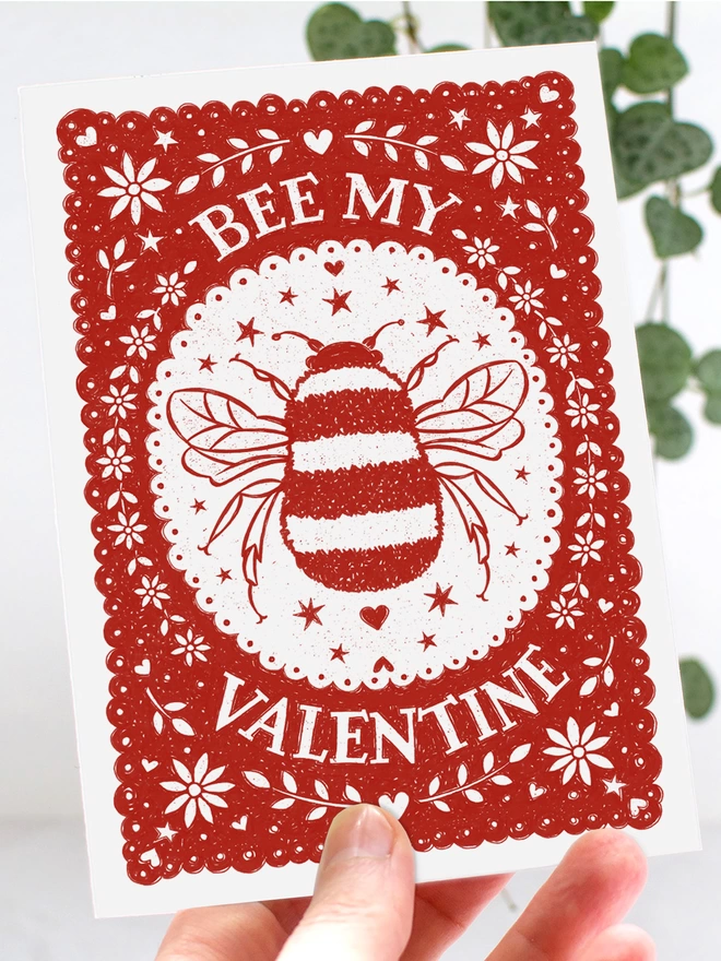 hands holding red and white bee my valentine card