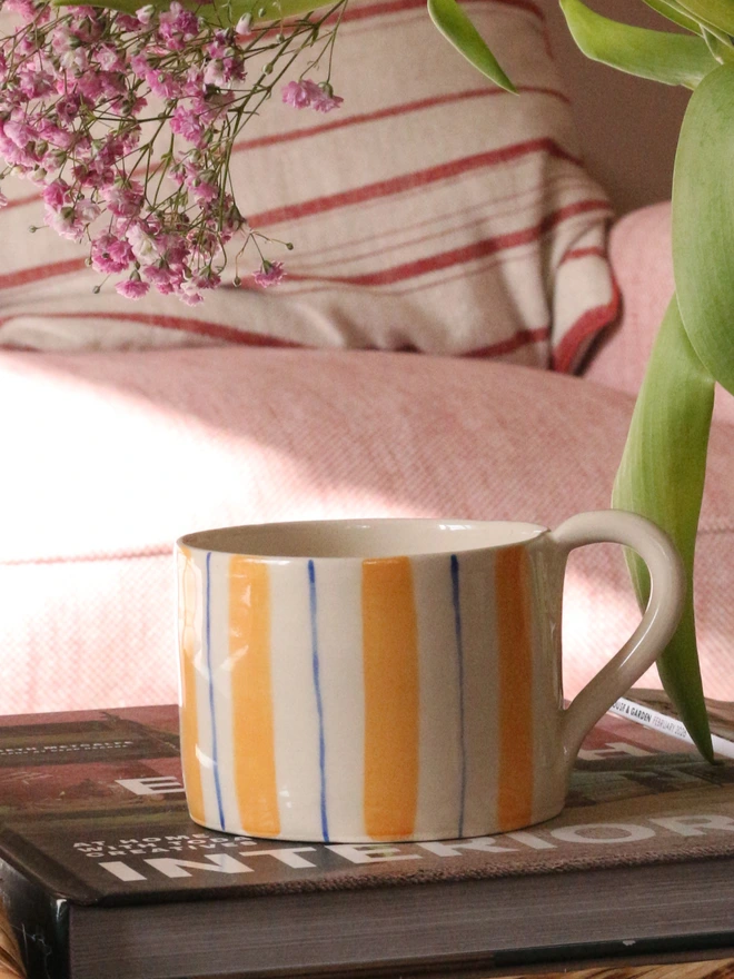 yellow and blue striped mugs hand painted and handmade in stoneware ceramics